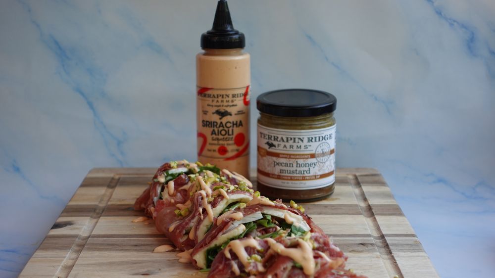 Prosciutto Sushi Roll with Pecan Honey Mustard and Sriracha Aioli Squeeze